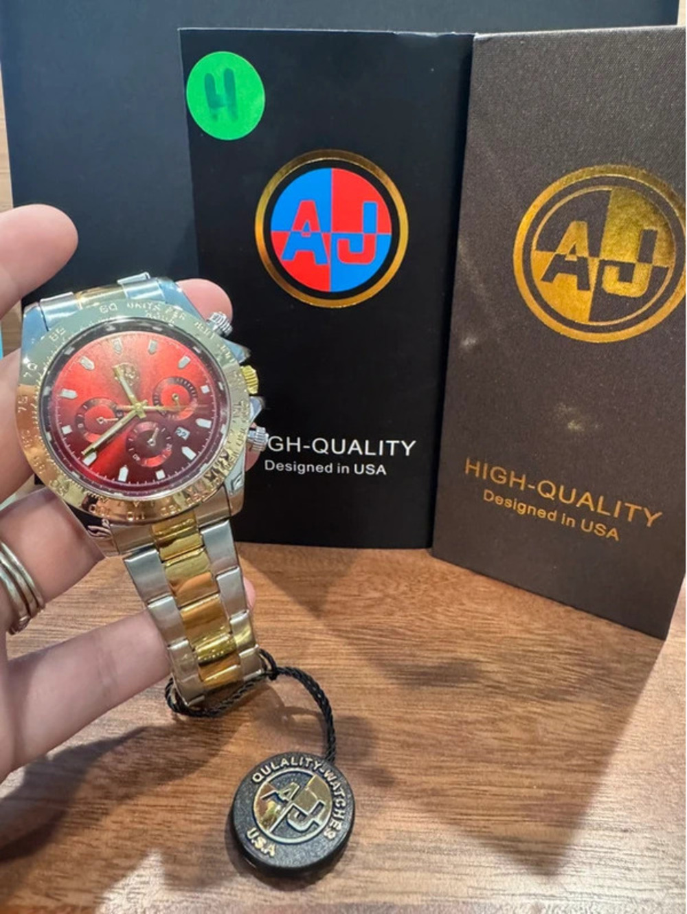 AJ watch, stainless steel, gold & silver toned, crimson red face